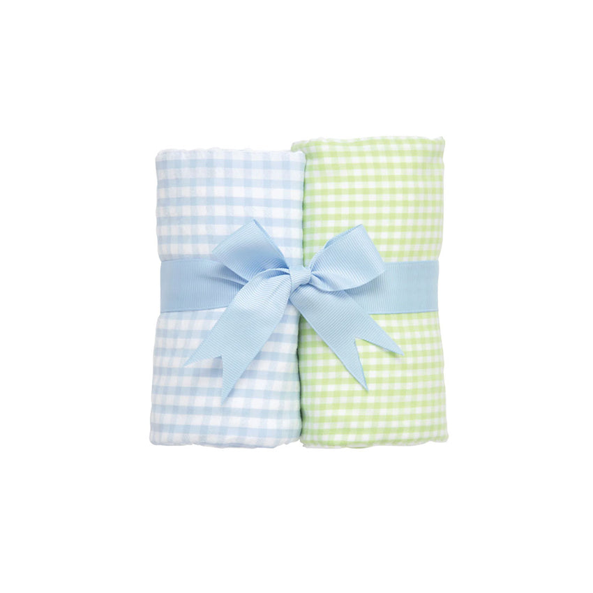 Two rolled checkered burp cloths - green and white check and blue  and white check - with a blue bow on a white background.