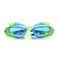 Pair of green and blue swim goggles with shark fin design on a white background.