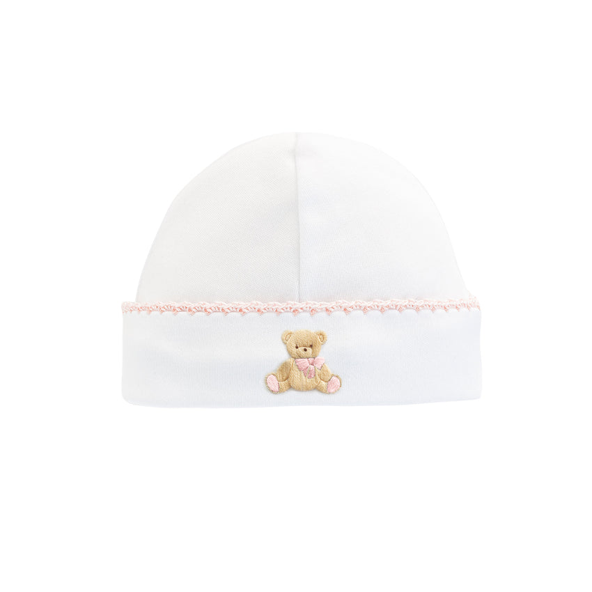 Pink trimmed white baby hat with an embroidered teddy bear 
