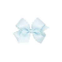 Light blue bow with scalloped edges on a white background.