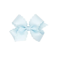 Light blue bow with scalloped edges on a white background.