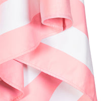Close-up of a pink and white checkered beach towel on white background.
