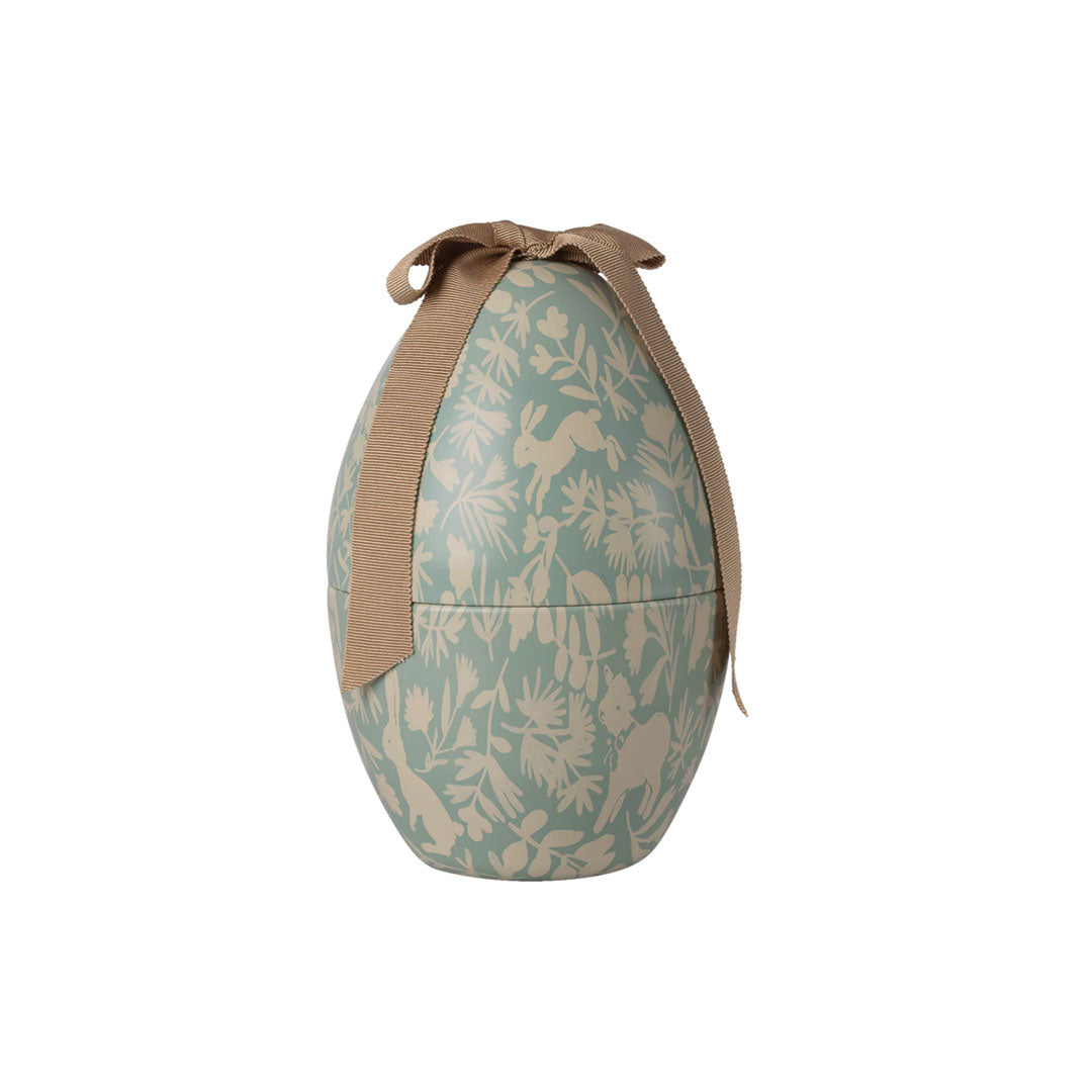 Decorative blue egg-shaped container with a pattern and brown ribbon on a white background