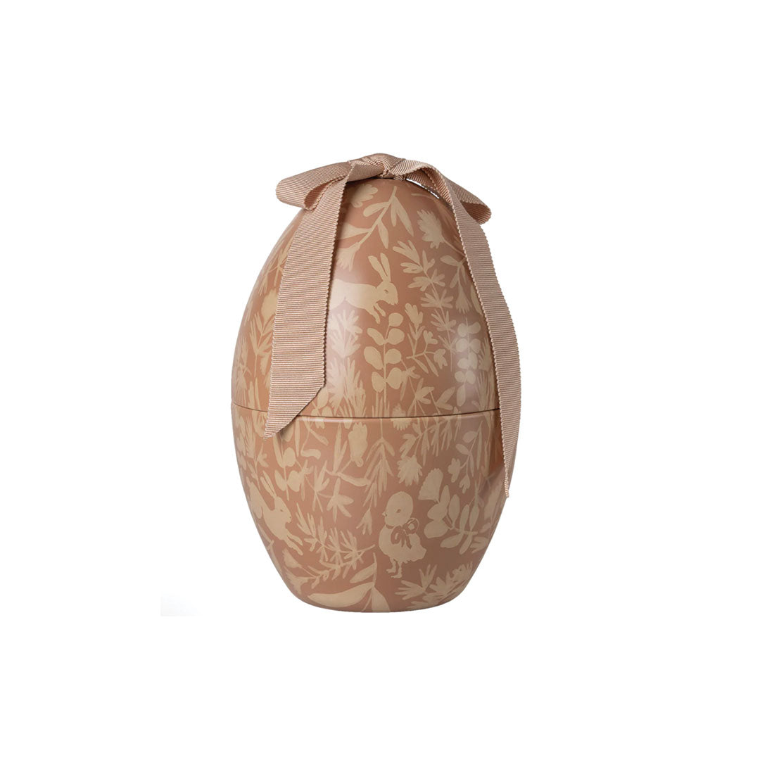 Decorative egg-shaped container with floral pattern and ribbon on a white background.