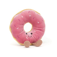 Pink plush donut toy with a smiling face 
