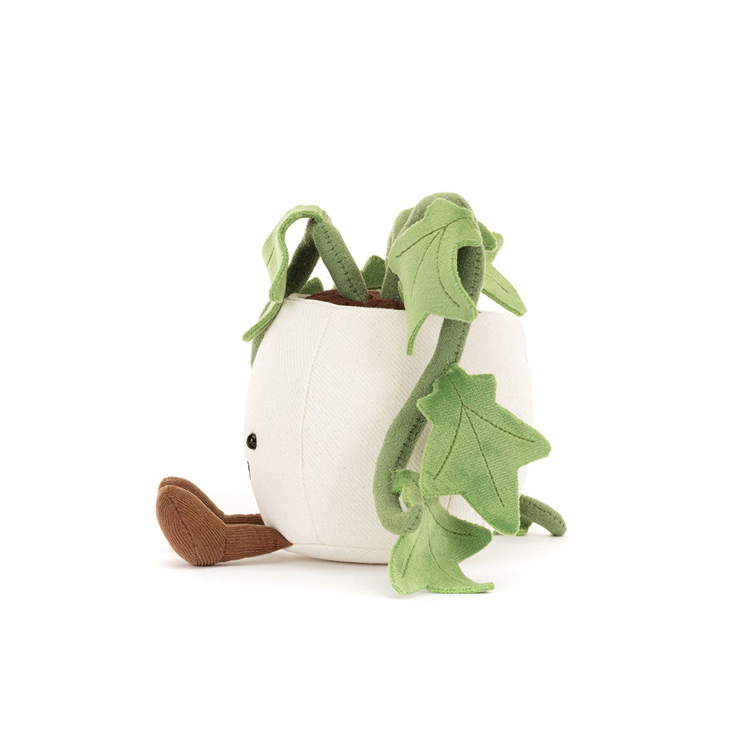 Side view of a plush toy plant with green leaves and a white pot on a white background.