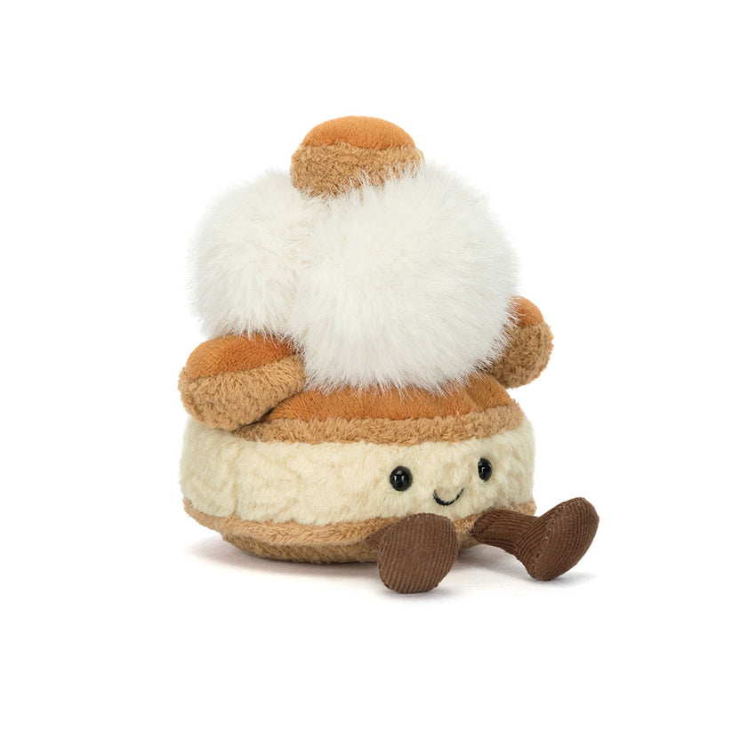 Plush toy resembling a cream puff with a brown top on a white background.