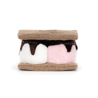 Back view of a  plush s'mores toy of two marshmallows sandwiched between brown textured bottoms, with one marshmallow in white and one in light pink, topped with dark brown chocolate drizzle, on a plain white background.
