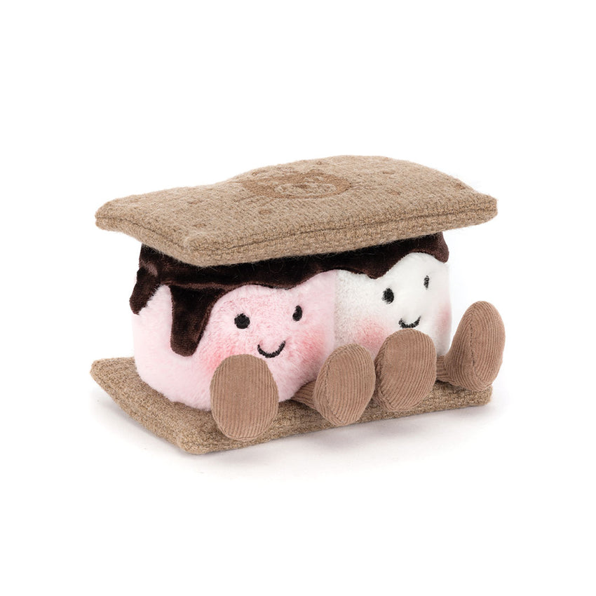 A plush s'mores toy with a white and pink marshmallows and faux-chocolate icing, and tan textured graham cracker tops and sides, shown on a plain white background.
