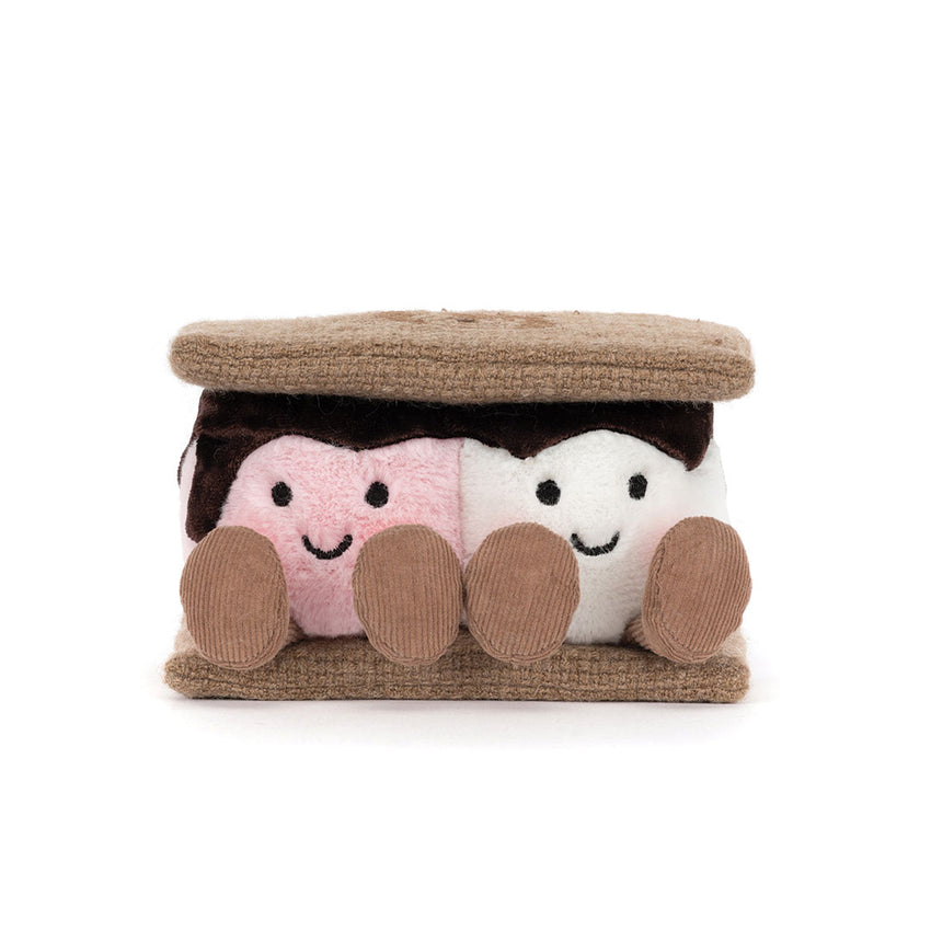 A plush s'mores-themed toy shaped like two marshmallows under a brown cracker with pink and white faces and brown feet, photographed on a clean white background.