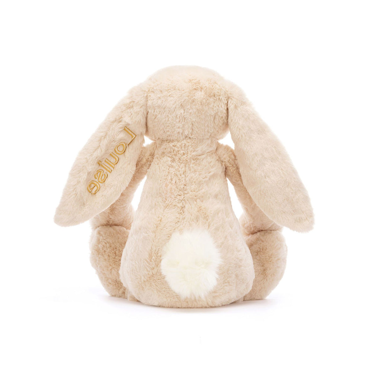 Back view of a cream colored bunny stuffed animal with a personalized ear embroidery on a white background.