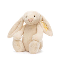 Cream colored bunny stuffed animal with a personalized ear embroidery on a white background.