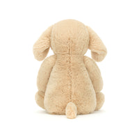 Back view of beige plush bunny toy on a white background.