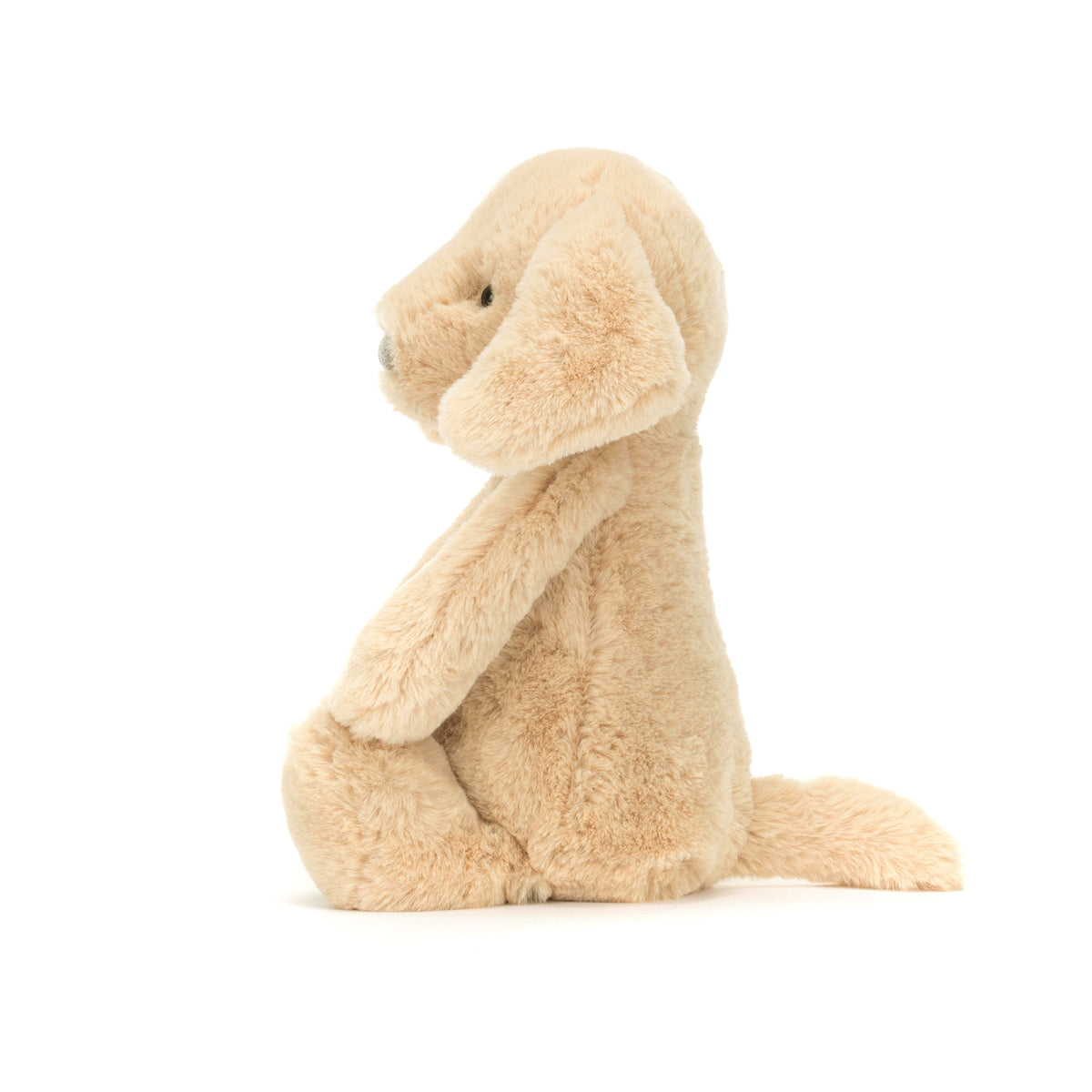 Side view of plush toy dog with a white background.