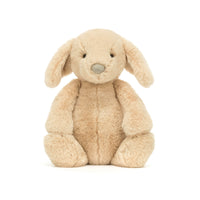 Beige plush bunny toy on a white background.