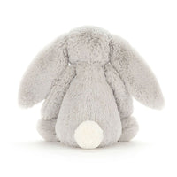 Back view of a  light silver gray plush bunny toy shown from the back, featuring floppy ears, a soft textured body, and a contrasting white circular tail, photographed on a clean white background.