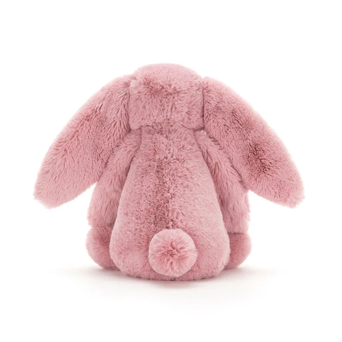 A pink plush bunny toy shown from the back, featuring long floppy ears, a soft furry body, and a small pom-pom tail, photographed on a clean white background.