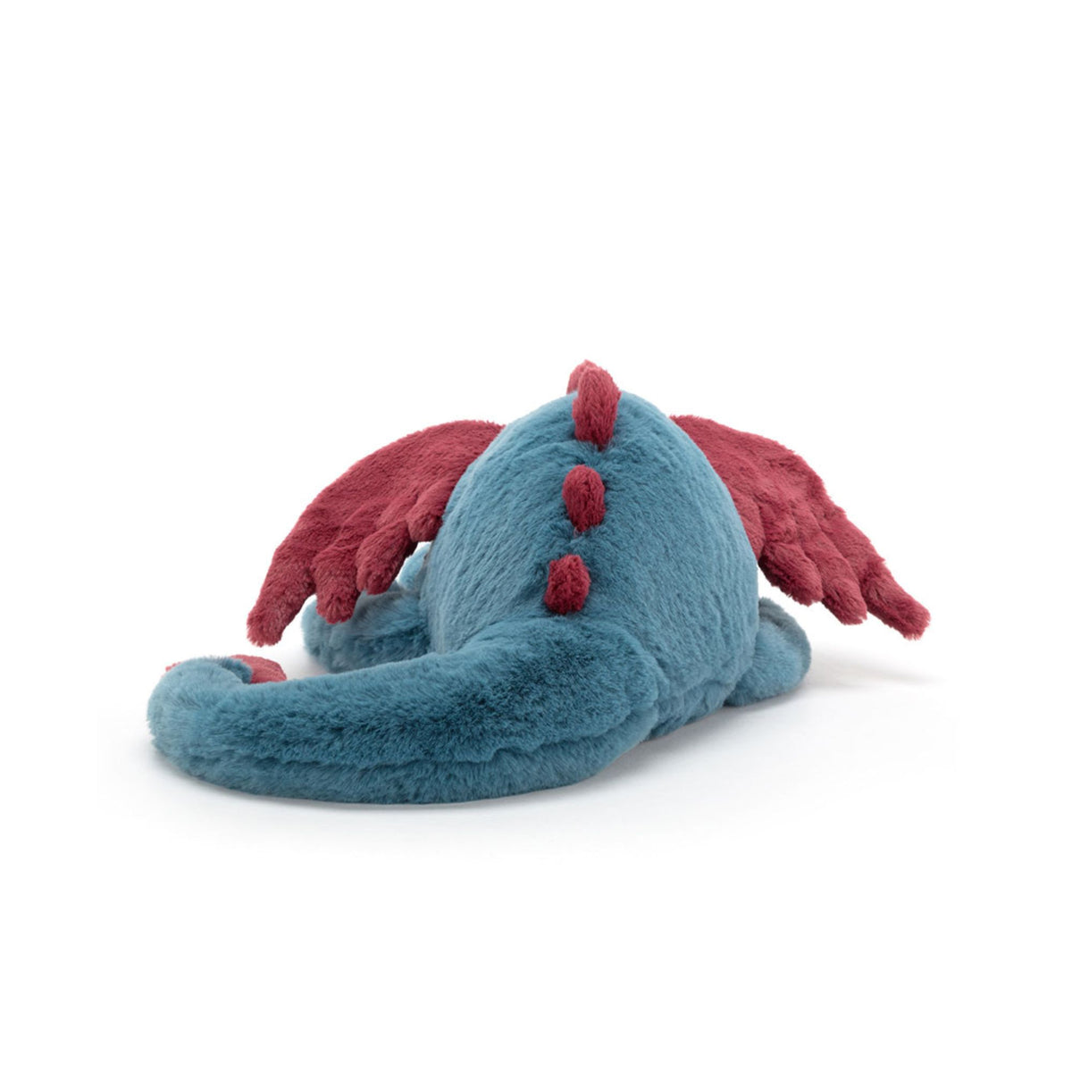 Back view of a plush dragon toy in teal blue with dark red wings and red back spikes, photographed on a clean white background.