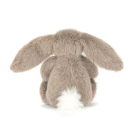 Back view of a plush bunny toy with long ears on a white background.