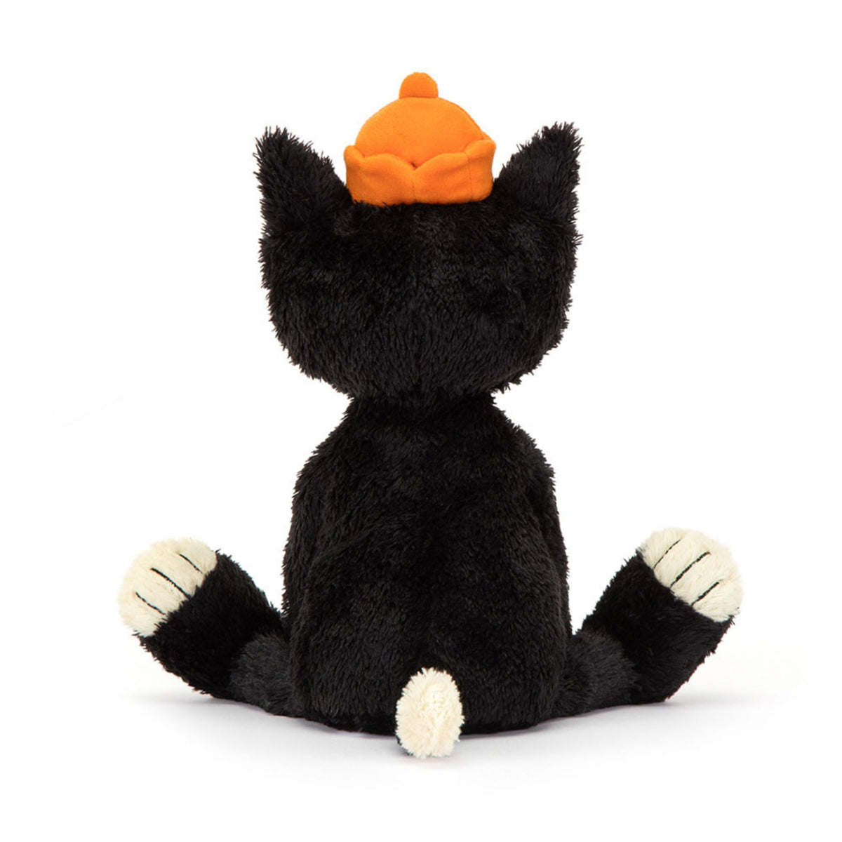 The back of a black and white plush cat stuffed animal wearing an orange hat on a white background.