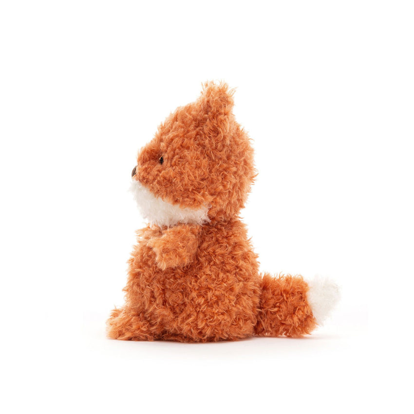 Small orange fox plush toy sitting on its side on a white background.
