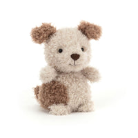 Stuffed animal dog with brown and white fur on a white background