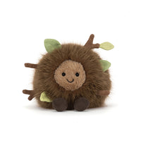 Front view of a stuffed round toy that is a bunch of dirt, leaves and twigs shown on a white background.