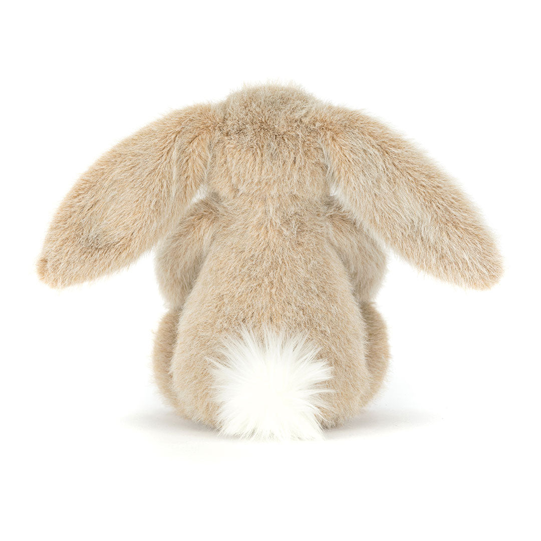 Back view of  a stuffed bunny toy with long ears on a white background.