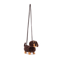 dark brown and tan plush sausage dog shoulder bag on a white background