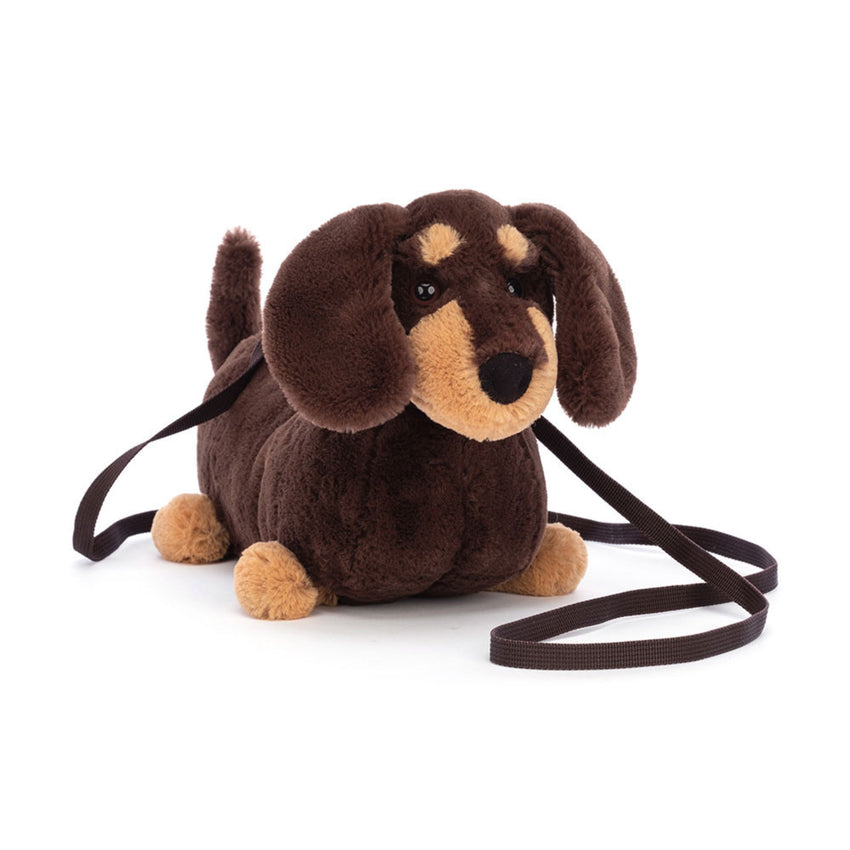dark brown and tan plush sausage dog shoulder bag on a white background
