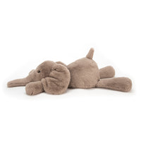 Side view of plush elephant toy on a white background.