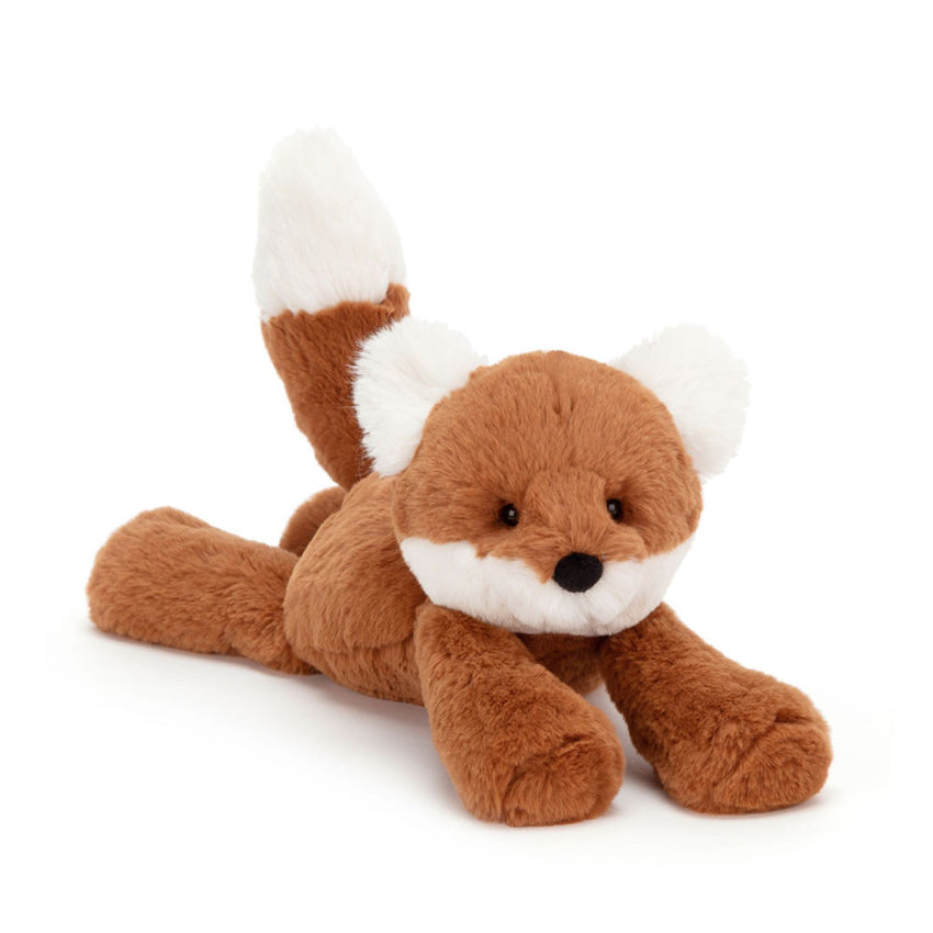 An orange and white fox stuffed animal plush laying down on a white background.