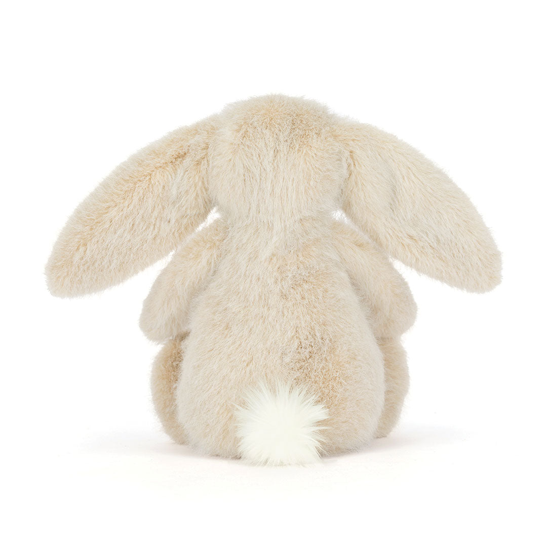 Back view of a  plush stuffed bunny toy, featuring long floppy ears, soft cream-colored fur, and a fluffy white tail, photographed on a clean white background.