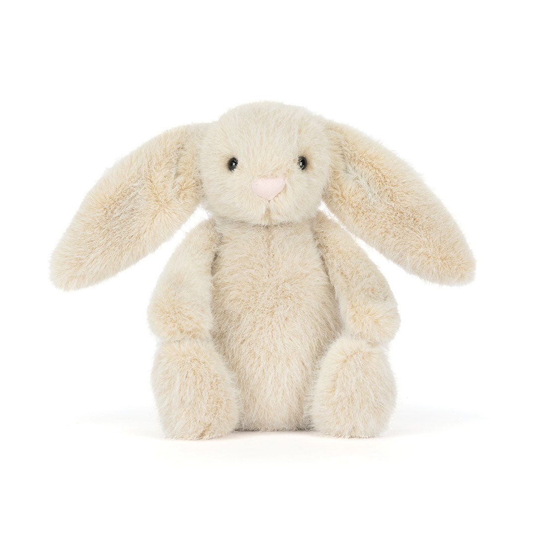 A plush stuffed bunny toy in a soft cream-beige color with long floppy ears, small black eyes, and a tiny pink nose, photographed on a clean white background.