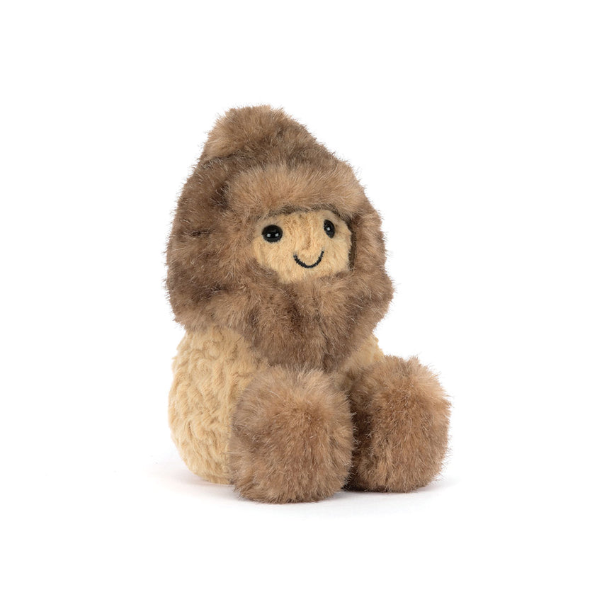 A small plush stuffed peanut with a shaggy brown hood and shoes on a cream-colored body, sitting on a plain white background.