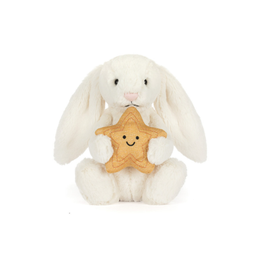 White plush bunny holding a star-shaped cookie with a smiley face on a white background