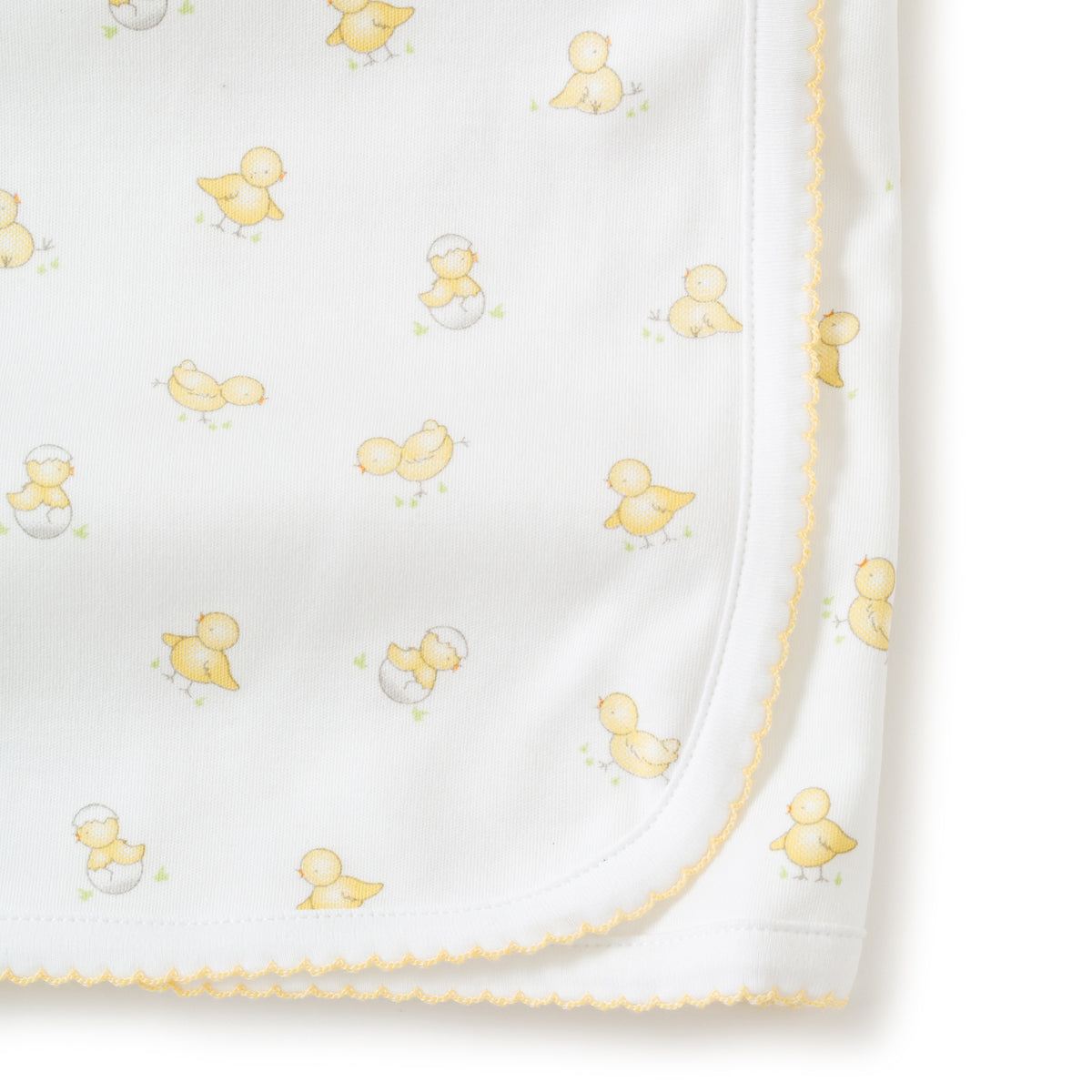 Close up of white baby receiving blanket with  yellow duck patterns on a white background.