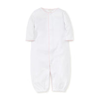 White converter gown with pink trim on a white background.