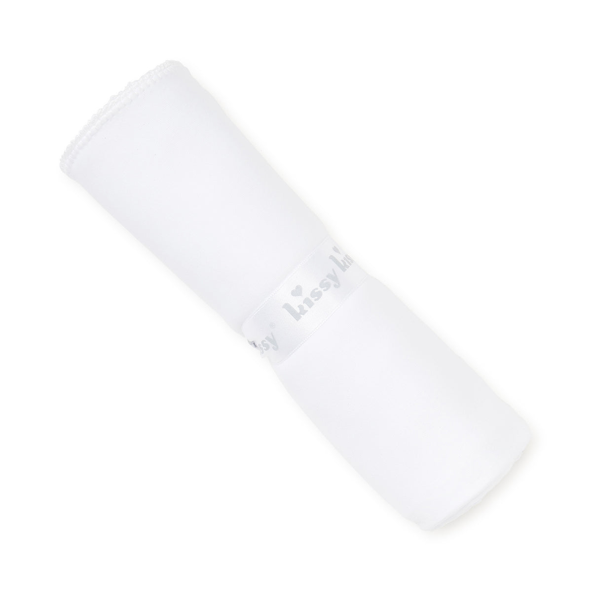 Rolled white blanket with ribbon  on a white background.