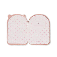 A pink plush notebook-shaped pouch with a polka dot pattern, featuring cat ears on the left side and a small pocket on the right side, shown against a plain white background.