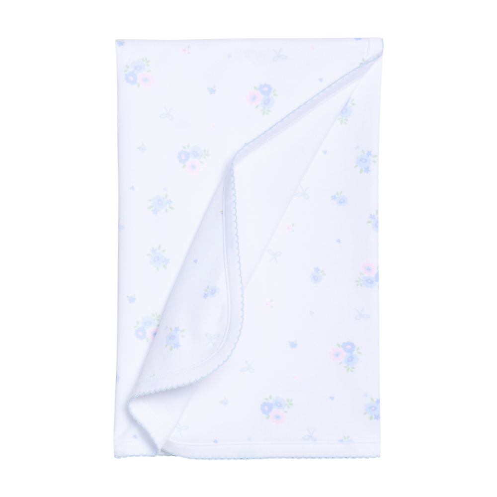 White baby blanket with blue floral patterns on a white background.