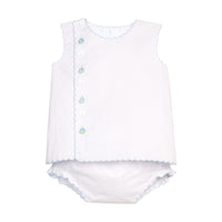White two-piece baby outfit with off-center buttons and blue trim on a white background.