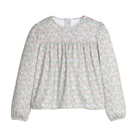 Green and pink floral blouse with long sleeves on a white background.