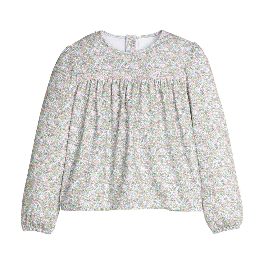 Green and pink floral blouse with long sleeves on a white background.