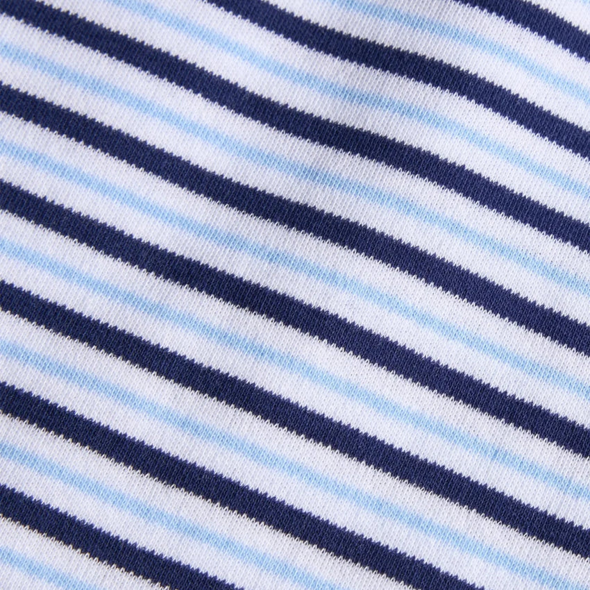 Close-up of a striped knit fabric with alternating navy blue, white, and light blue diagonal stripes.