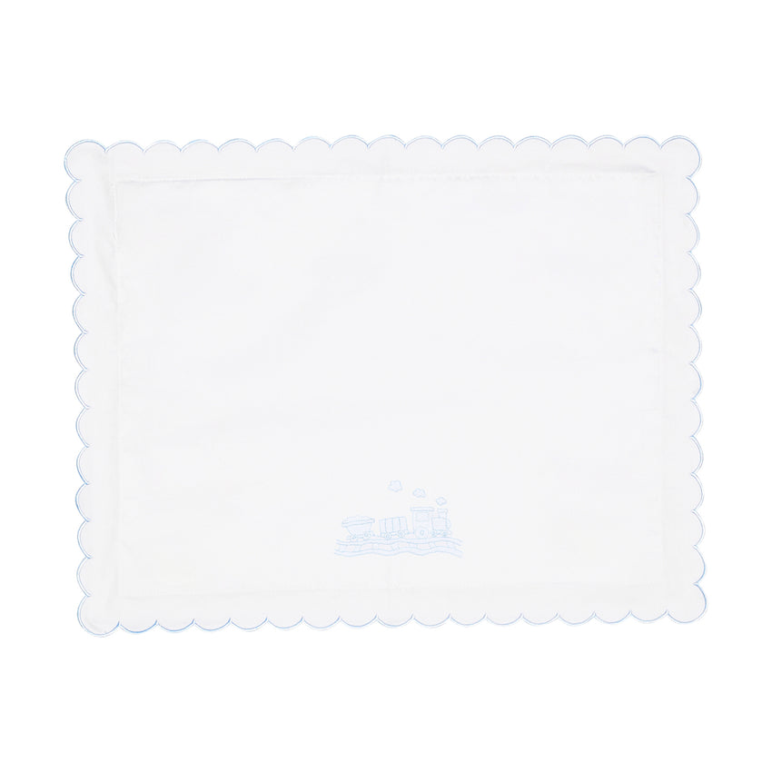 White scalloped pillow with train design shown on a white background.
