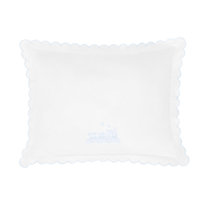 White pillow with scalloped edge and train design shown on a white background.