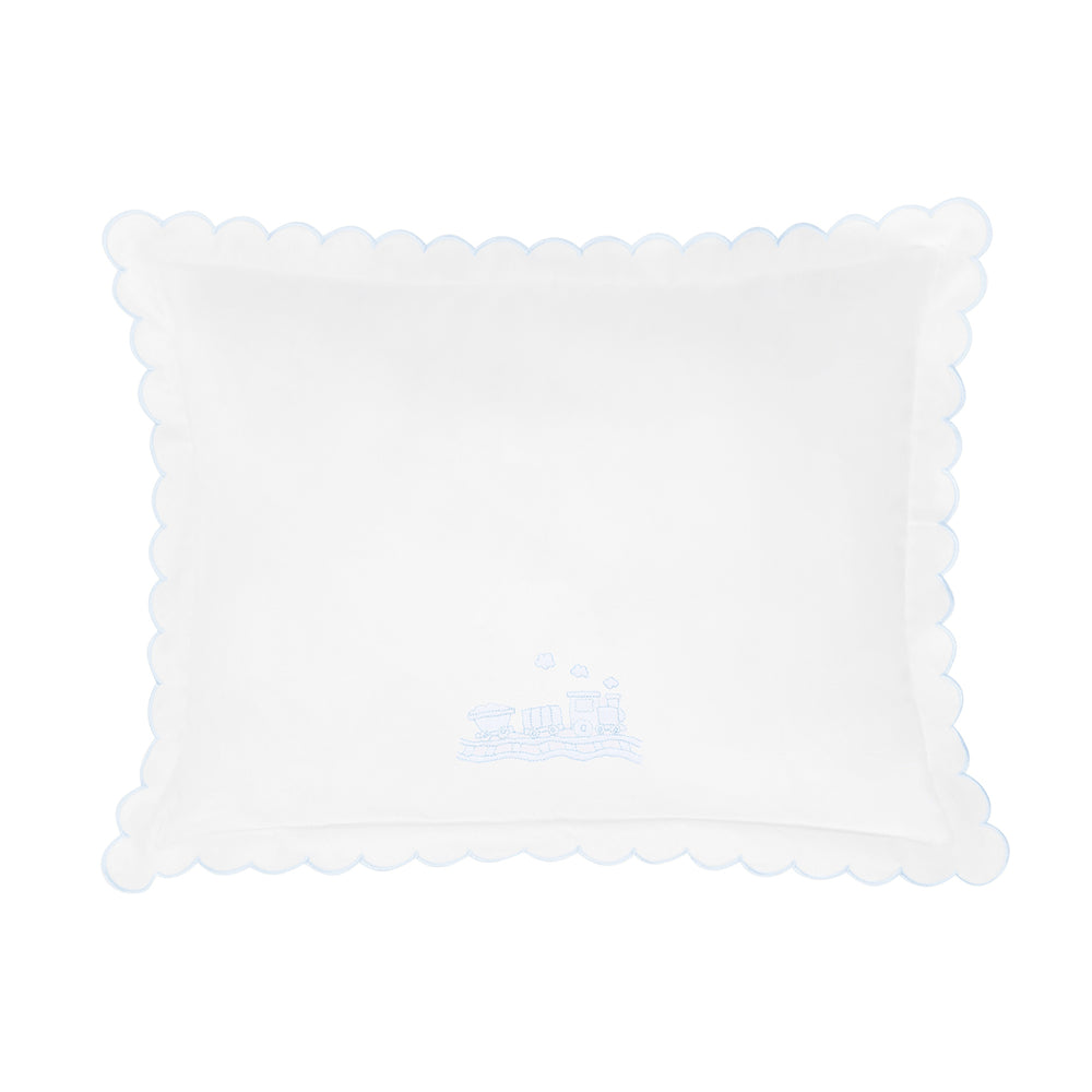 White pillow with scalloped edge and train design shown on a white background.