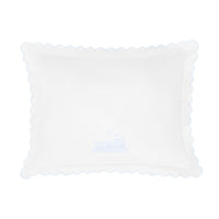 White pillow with scalloped edge and train design shown on a white background.