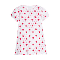White dress with red strawberry pattern on a white background.